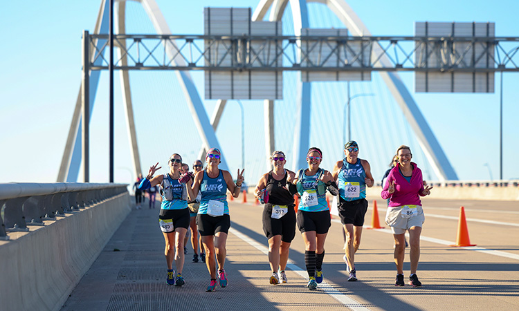 Runners crossing the I-74 Bridge at the Quad Cities Marathon