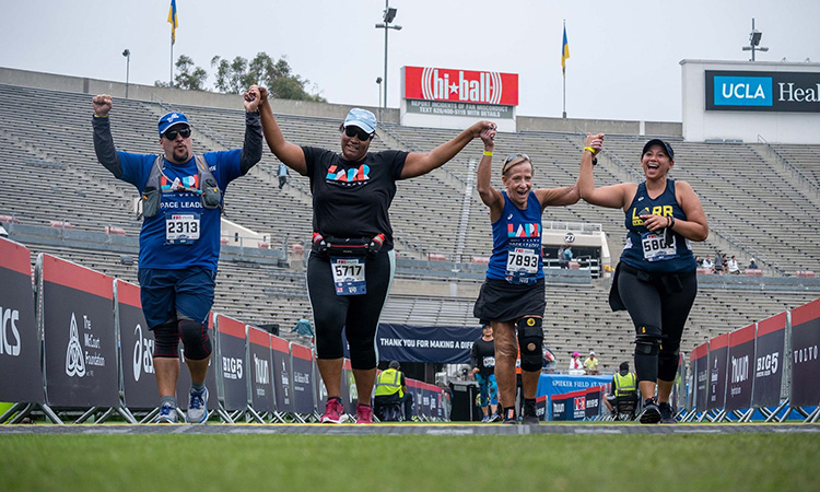 Runners finish on the field at the Rose Bowl Half