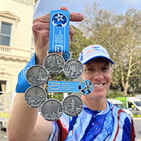 RaceRaves co-founder Mike Sohaskey holding his Six Star Medal