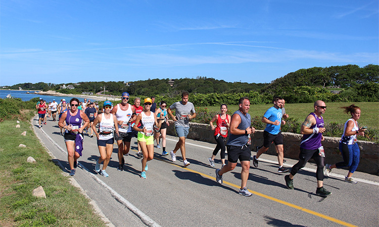 Runners cruise along the summer coastline at the Falmouth Road Race