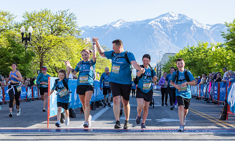 Family crossing the finish line at the Ogden Marathon