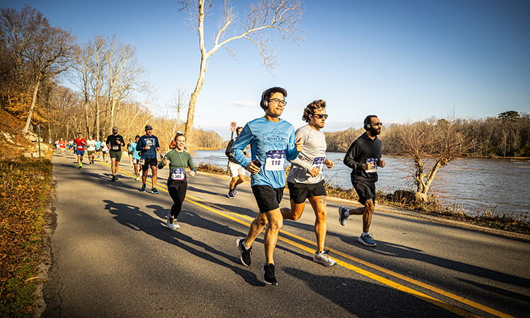 Runners cruise alongside the James River at the River City Half Marathon