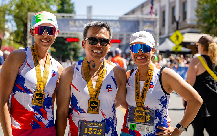 Three happy finishers at the 2025 Santa Rosa Marathon finish line