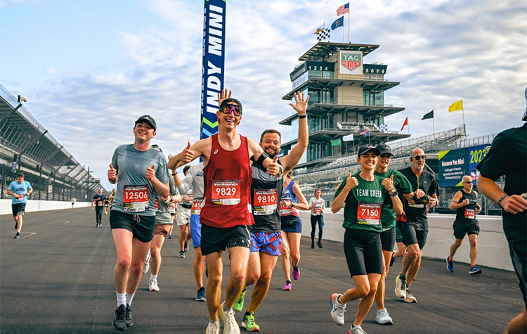 Runners on the track at the Indianapolis Motor Speedway during the IU Health 500 Festival Mini-Marathon aka Indy Mini